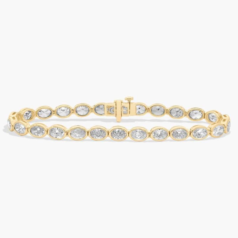 7 " Oval Cut Diamond E/W Bezel Set Tennis Bracelet In 14K Yellow Gold (10 Ct. tw. - H-I / SI1-SI2)